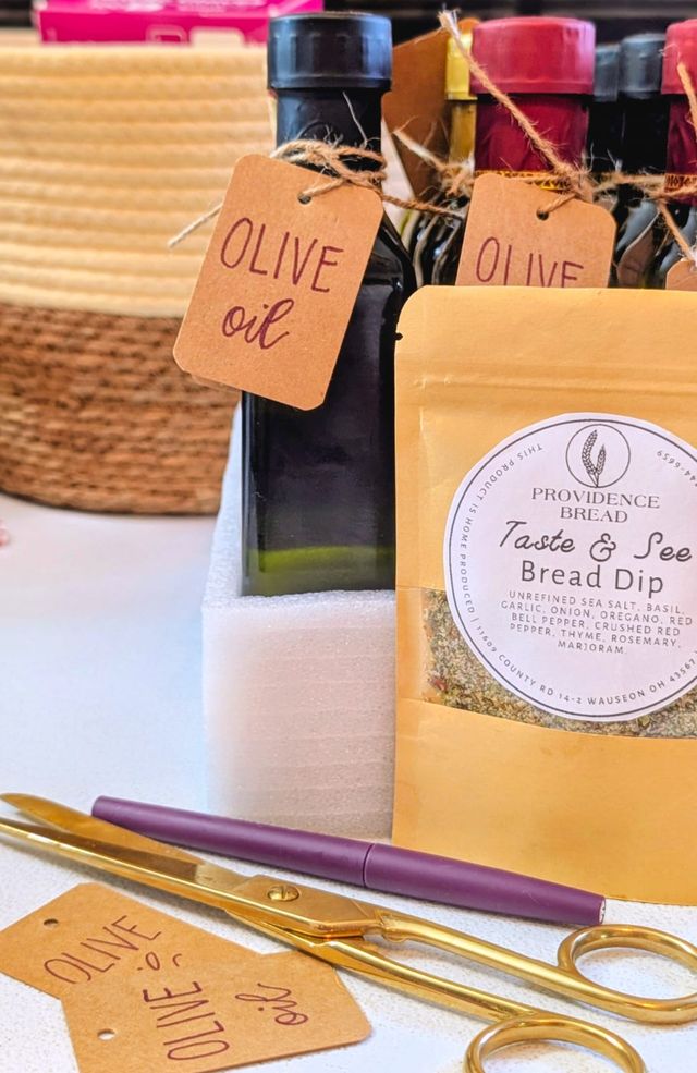 Taste & See Bread Dip pouch with bottles of olive oil tied with kraft tags