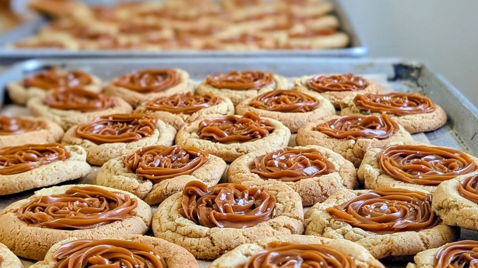 Cookies with golden caramel-colored centers on a baking tray