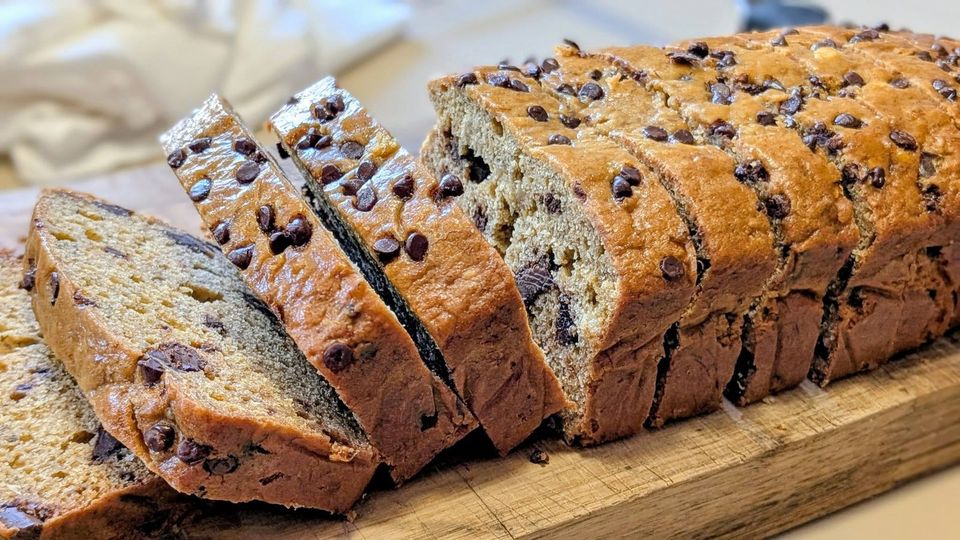A sliced loaf with chocolate chips on a wooden board