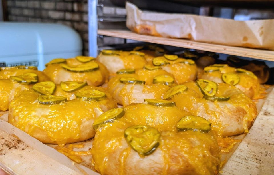 Golden bakes topped with melted cheese and pepper slices