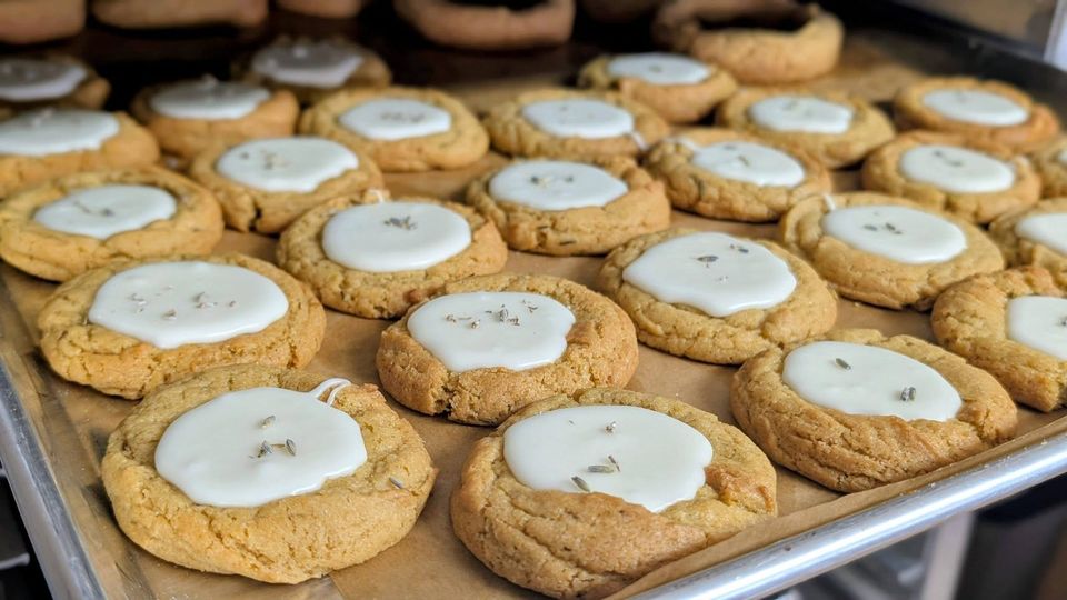 Soft cookies with white icing on a baking tray