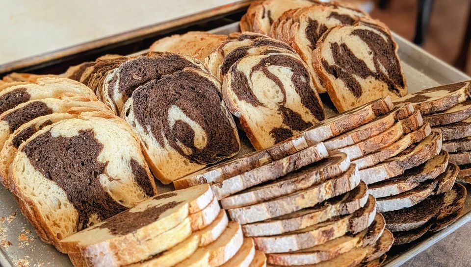 Sliced loaves with a dark and light swirl, stacked on a tray